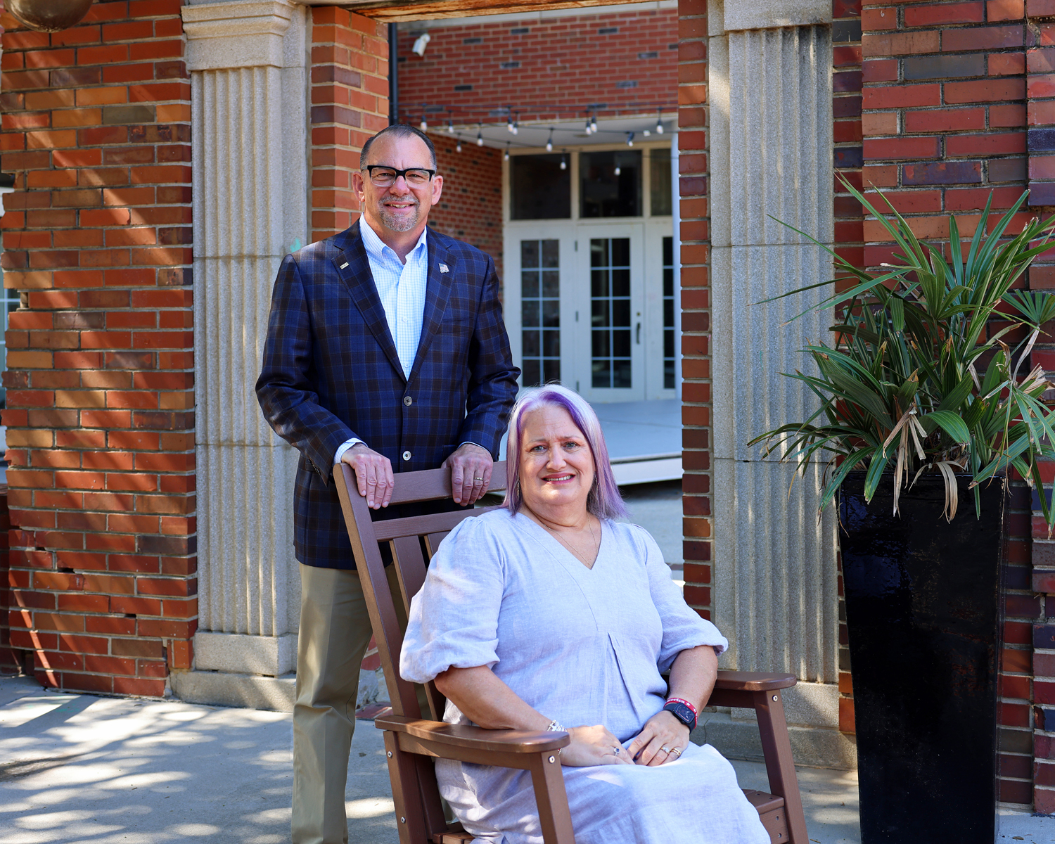 Financial advisors standing outside their Aiken office ready to help clients with wealth management and retirement planning.